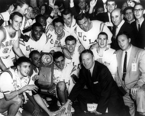 After winning his first title, John Wooden removed his glasses to celebrate with his 1964 championship team.